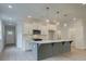 Modern kitchen with gray island, white cabinets, and stainless steel appliances at 746 Trevett Way, Marietta, GA 30062