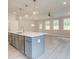 Open concept kitchen and dining area with gray island, white cabinets and hardwood floors at 746 Trevett Way, Marietta, GA 30062