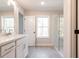 Bright bathroom featuring a walk-in shower, large windows, and double sink vanity at 754 Trevett Way, Marietta, GA 30062