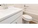 Bright bathroom with a white single sink vanity and a tub with shower at 754 Trevett Way, Marietta, GA 30062