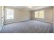 Spacious bedroom with two windows and plush carpeting at 754 Trevett Way, Marietta, GA 30062