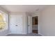 Neutral bedroom with a double window and closet, plus an open door to another room at 754 Trevett Way, Marietta, GA 30062