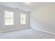 Well-lit bedroom with carpet flooring and two windows at 754 Trevett Way, Marietta, GA 30062