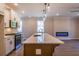 Modern kitchen features a central island with a sink and a fireplace in the living area at 754 Trevett Way, Marietta, GA 30062