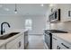 Modern kitchen with white cabinets, quartz countertops, and stainless steel appliances at 754 Trevett Way, Marietta, GA 30062