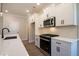 Well-equipped kitchen with stainless steel appliances and white cabinets and quartz countertops at 754 Trevett Way, Marietta, GA 30062