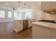 Modern open kitchen featuring stainless steel appliances, an island, and hardwood floors at 754 Trevett Way, Marietta, GA 30062