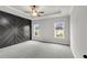 Spacious main bedroom with gray walls, carpeting, and a geometric accent wall at 8950 Callaway Dr, Winston, GA 30187