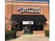 Anytime Fitness gym exterior, brick building with black awning at 11555 Chatham Dr, Hampton, GA 30228