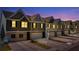 Townhomes at night showcasing the lighting and architectural details at 11555 Chatham Dr, Hampton, GA 30228