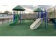 Playground with green turf and play structures at 11555 Chatham Dr, Hampton, GA 30228