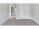 Bedroom with carpet flooring, neutral walls and double doors at 3686 Lockaby Way, Lawrenceville, GA 30044