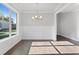 Bright dining room with hardwood floors, wainscoting, and a chandelier at 3686 Lockaby Way, Lawrenceville, GA 30044