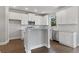 Modern kitchen featuring white cabinets, granite countertops, and an island at 3686 Lockaby Way, Lawrenceville, GA 30044