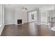 Open living room with hardwood floors and a fireplace at 3686 Lockaby Way, Lawrenceville, GA 30044