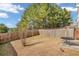 Fenced backyard with a patio table and a large tree providing shade at 593 Shadow Valley Ct, Lithonia, GA 30058