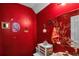 Small bathroom with red walls, decorative accents, and a mirrored medicine cabinet at 593 Shadow Valley Ct, Lithonia, GA 30058