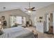 Main bedroom with king bed, access to balcony, and plenty of natural light at 593 Shadow Valley Ct, Lithonia, GA 30058