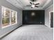 Spacious bedroom with gray carpeting, large windows, and a black accent wall at 8870 Callaway Dr, Winston, GA 30187