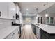 Modern kitchen with white cabinets, quartz countertops and stainless steel appliances at 8870 Callaway Dr, Winston, GA 30187