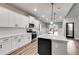 Modern kitchen with white cabinets, quartz countertops and stainless steel appliances at 8870 Callaway Dr, Winston, GA 30187