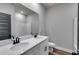 Bathroom boasts double sinks, white cabinets, and a large mirror at 8920 Callaway Dr, Winston, GA 30187