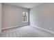 Simple bedroom with gray walls, carpet flooring and a large window at 8920 Callaway Dr, Winston, GA 30187