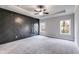 Spacious main bedroom with dark accent wall and plush carpeting at 8920 Callaway Dr, Winston, GA 30187