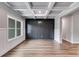 Dining room with dark gray wall paneling, hardwood floors, and a large window at 8920 Callaway Dr, Winston, GA 30187