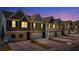 Attractive townhomes at night, showcasing modern design and landscaping at 11571 Chatham Dr, Hampton, GA 30228