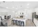 Modern kitchen with white cabinets, granite countertops and a large island at 11571 Chatham Dr, Hampton, GA 30228