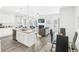 Open-concept kitchen with granite island, stainless steel appliances, and luxury vinyl flooring at 11571 Chatham Dr, Hampton, GA 30228