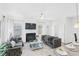Bright living room with a fireplace, and access to the kitchen at 11571 Chatham Dr, Hampton, GA 30228