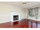 Living room with hardwood floors, fireplace and ceiling fan at 2980 Milford Sw Trl, Marietta, GA 30008