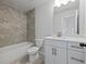 Modern bathroom with a white vanity, grey tile, and a bathtub at 4074 Hosch Retreat Dr, Buford, GA 30519