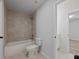 Clean bathroom featuring a bathtub, toilet and tiled flooring at 4074 Hosch Retreat Dr, Buford, GA 30519