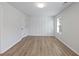 Well-lit bedroom featuring wood flooring and wainscoting at 4074 Hosch Retreat Dr, Buford, GA 30519