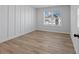 Bedroom with wood-look flooring and board and batten wall at 4074 Hosch Retreat Dr, Buford, GA 30519