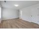 Spacious bedroom with wood-look flooring and an adjacent bathroom at 4074 Hosch Retreat Dr, Buford, GA 30519