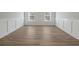 Versatile bonus room with hardwood floors and wainscoting at 4074 Hosch Retreat Dr, Buford, GA 30519