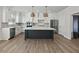 Modern kitchen with white cabinets, large island, and stainless steel appliances at 4074 Hosch Retreat Dr, Buford, GA 30519