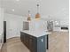 Open concept kitchen with island and view into living room at 4074 Hosch Retreat Dr, Buford, GA 30519