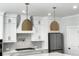 Modern kitchen with white cabinets and unique light fixtures at 4074 Hosch Retreat Dr, Buford, GA 30519