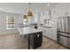 Modern kitchen with white cabinets, large island, and stainless steel appliances at 4074 Hosch Retreat Dr, Buford, GA 30519