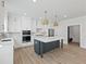 Modern kitchen with white cabinets, large island, and stainless steel appliances at 4074 Hosch Retreat Dr, Buford, GA 30519