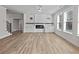 Open living room with hardwood floors, fireplace, and built-in cabinets at 4074 Hosch Retreat Dr, Buford, GA 30519