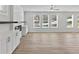 Spacious living room with hardwood floors, fireplace, and large windows at 4074 Hosch Retreat Dr, Buford, GA 30519