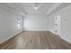 Main bedroom with tray ceiling, hardwood floors and board and batten at 4074 Hosch Retreat Dr, Buford, GA 30519