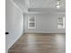 Spacious main bedroom with tray ceiling and hardwood floors at 4074 Hosch Retreat Dr, Buford, GA 30519