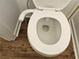 Close-up of toilet with modern bidet attachment and hardwood floor at 6002 Pat Mell Se Pl, Smyrna, GA 30080